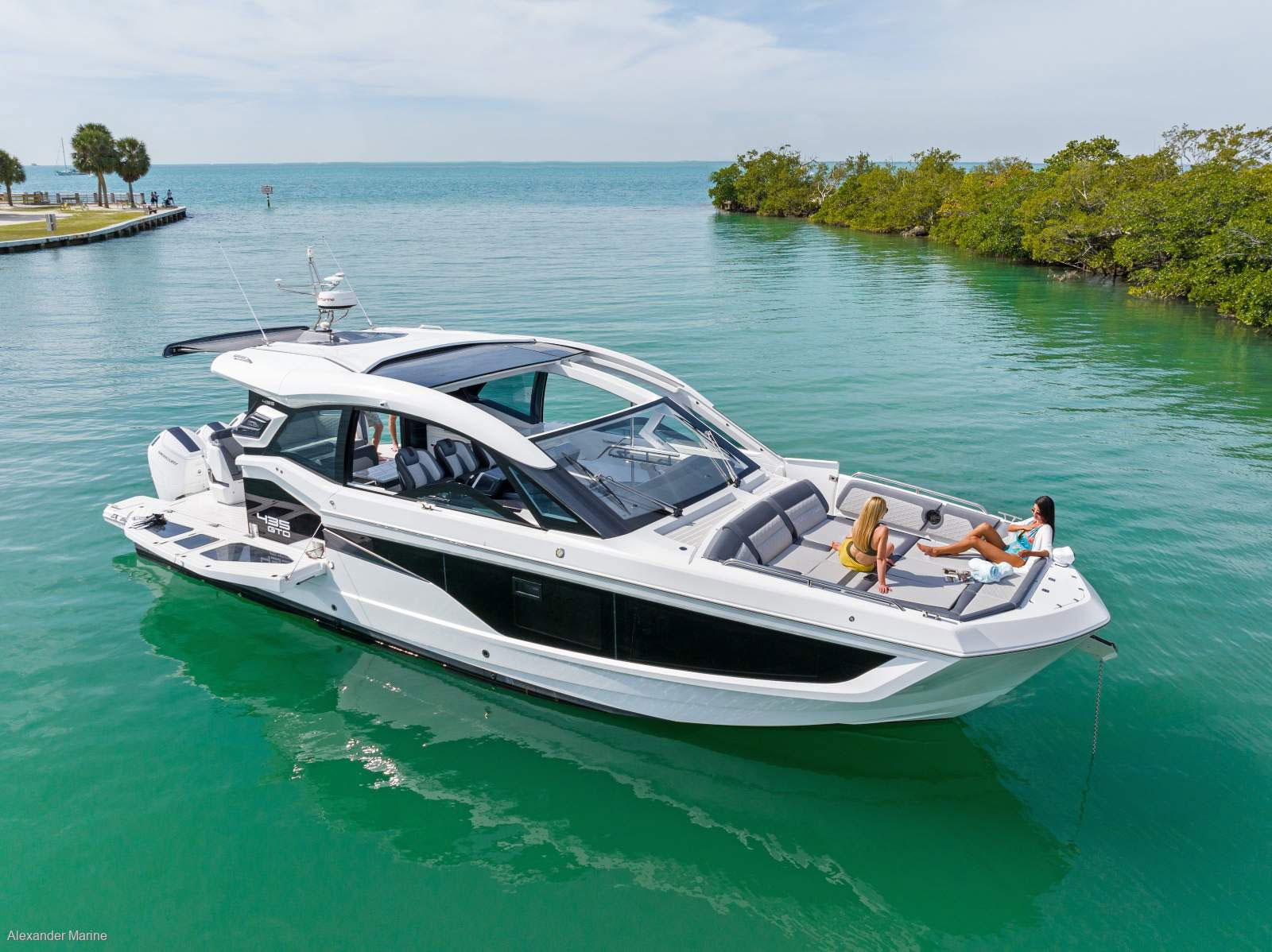 25m Galeon 800 Fly power yacht by Tony Castro Yachts cruising at sunset with sleek modern profile and illuminated superstructure reflected on calm water
