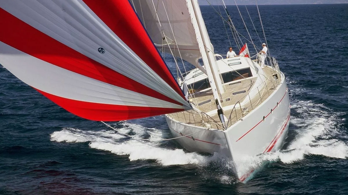 32m Red Sula sail custom yacht by Tony Castro Yachts with white hull and teak deck, heeling under large mainsail on deep blue open sea