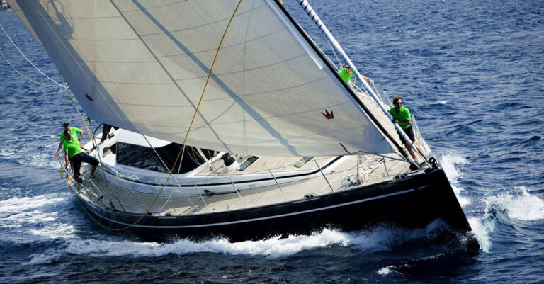 29m Jongert Scorpione Dei Mari sail custom yacht by Tony Castro Yachts with dark navy hull and crew on deck, racing under full sail on open blue sea