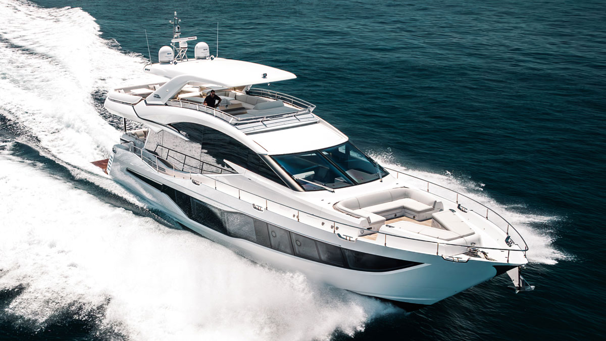 25m Galeon 800 Fly power yacht by Tony Castro Yachts cruising at sunset with sleek modern profile and illuminated superstructure reflected on calm water