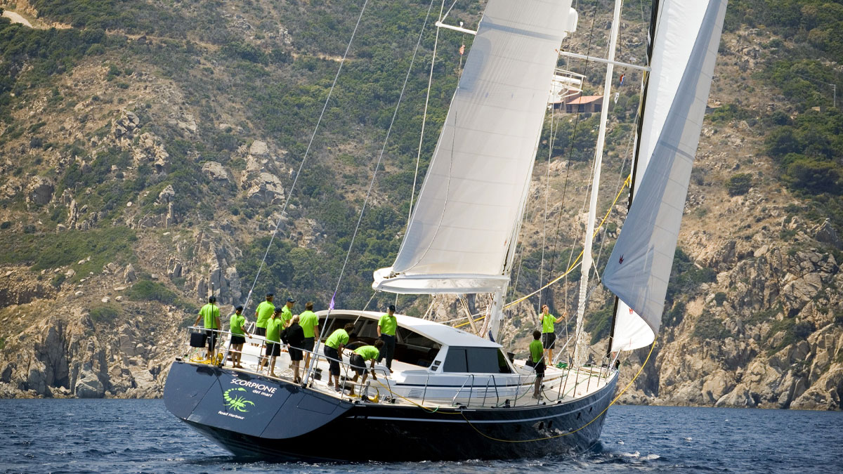 29m Jongert Scorpione Dei Mari sail custom yacht by Tony Castro Yachts with dark navy hull and crew on deck, racing under full sail on open blue sea