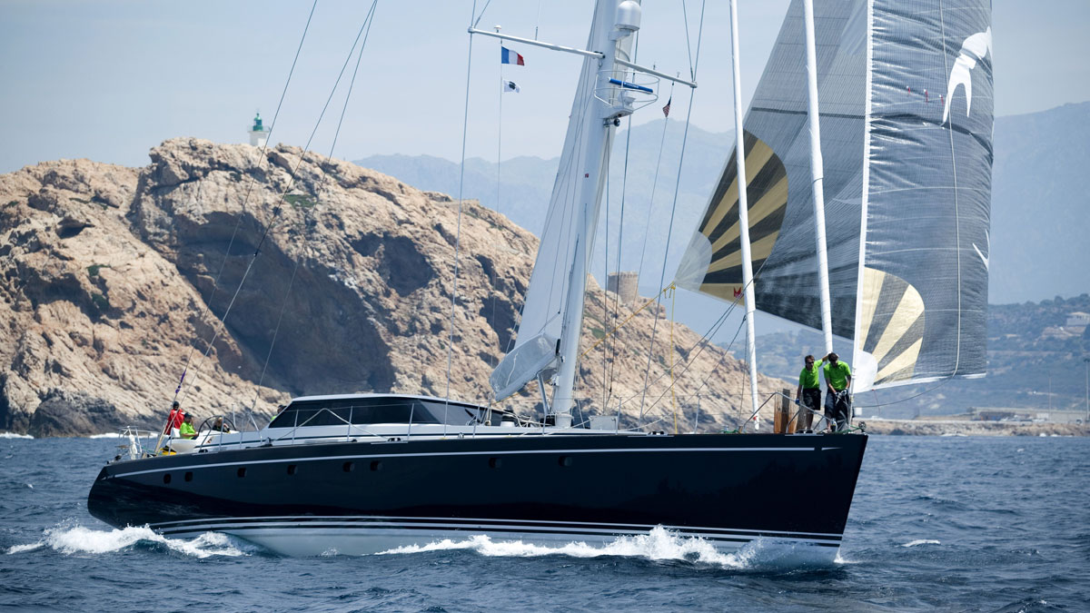 29m Jongert Scorpione Dei Mari sail custom yacht by Tony Castro Yachts with dark navy hull and crew on deck, racing under full sail on open blue sea