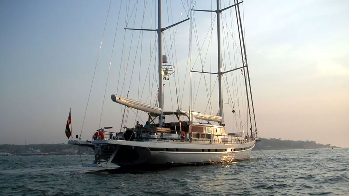42m Jongert Islandia sail custom yacht by Tony Castro Yachts with white hull and twin masts, anchored peacefully at dusk on calm water